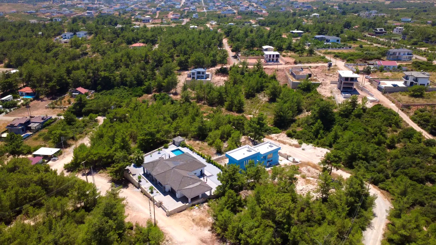 Drone view of a villa with pool among pine forest in Seyrantepe, Didim