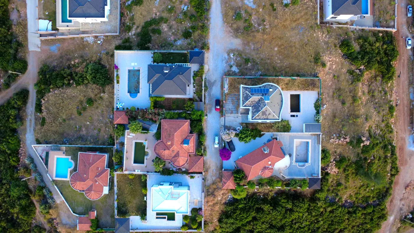Top-down drone view of villas with pools and gardens in Yeşiltepe, Didim